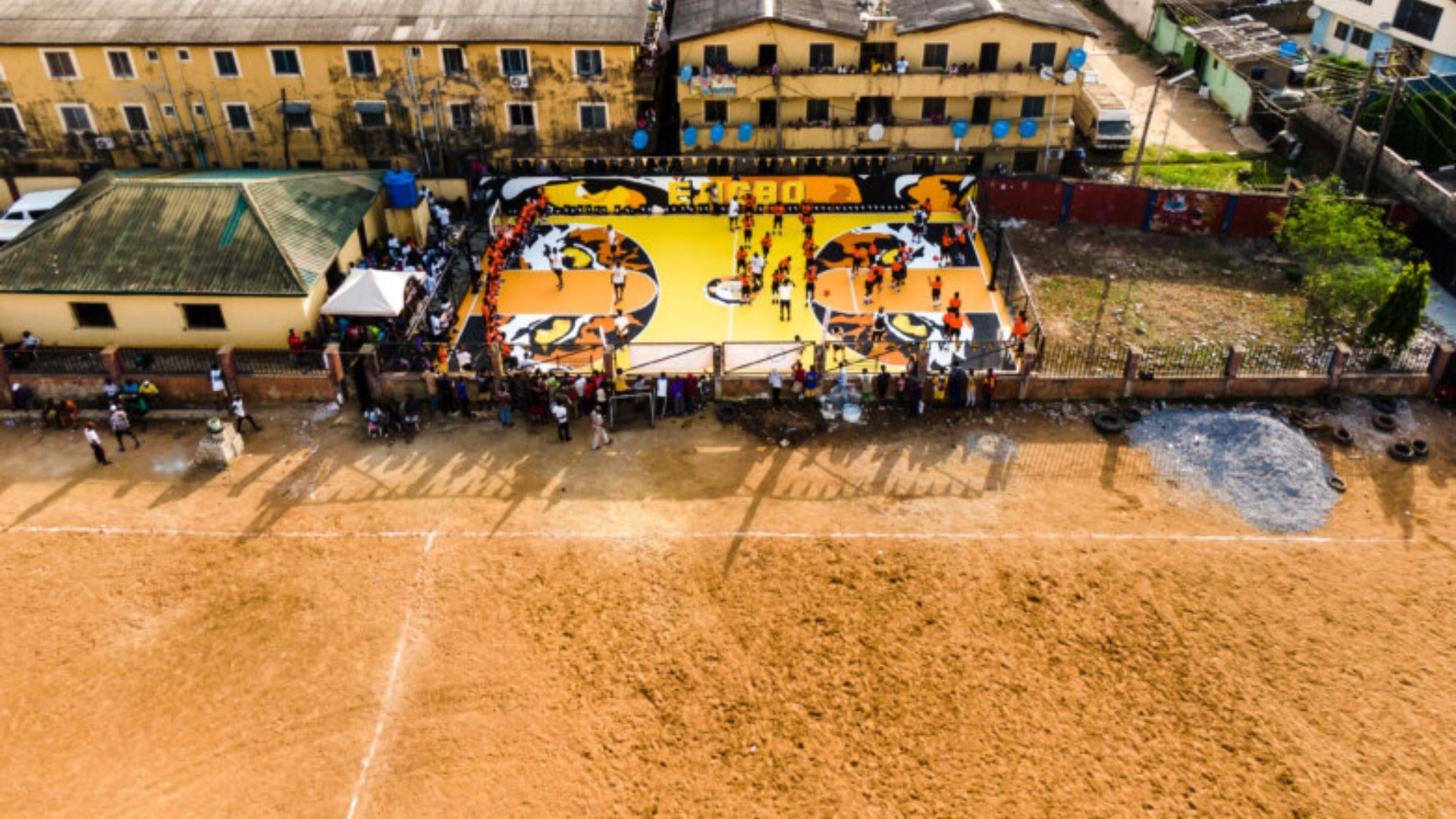 The grassless pitch of the Ejigbo Stadium alongside the basketball court built by Giants of Africa. 