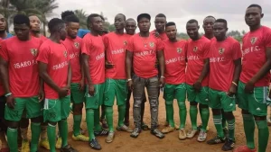 Lucky Osaro Godwin, founder of Osaro International Sports Academy, and some OISA players