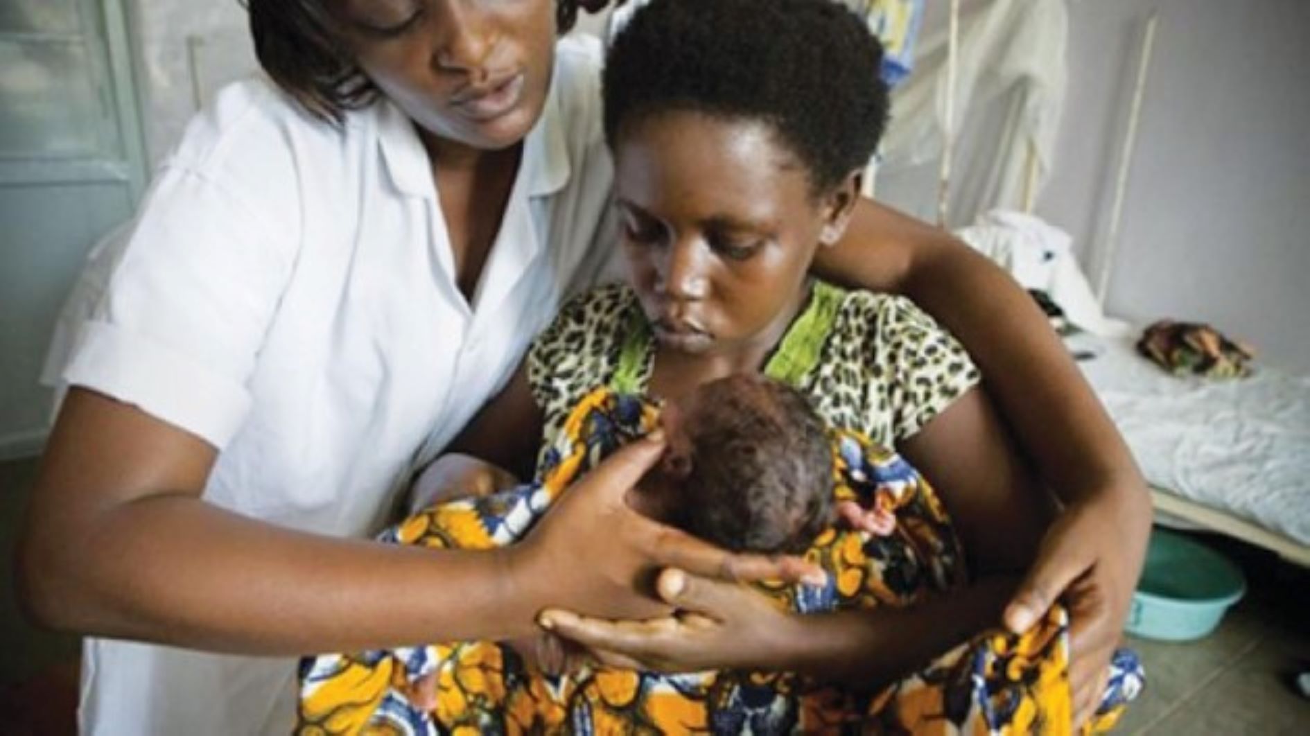 Nurse helping a young mother_1