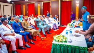 President Bola Tinubu (standing) addressing leaders and members of the RHA during the visit.