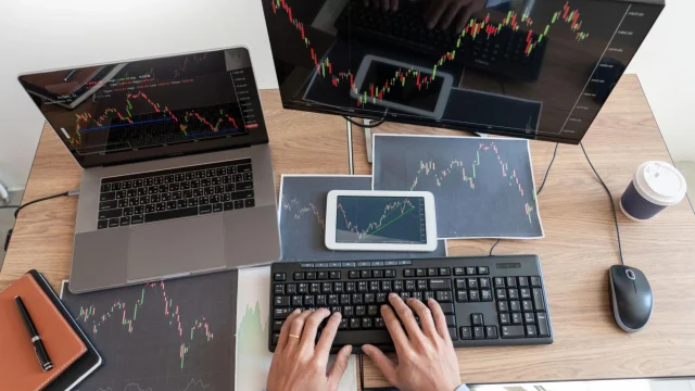 Working business man, team of broker or traders talking about forex on multiple computer screens of stock market invest trading financial graph charts data analysis