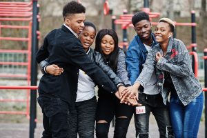 Young millennials african friends on outdoor gym. Happy black pe