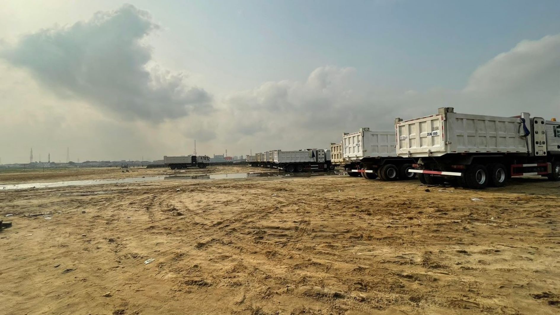 Trucks parked at a section of demolished Otumara already sandfilled and being auctioned for N200m per plot