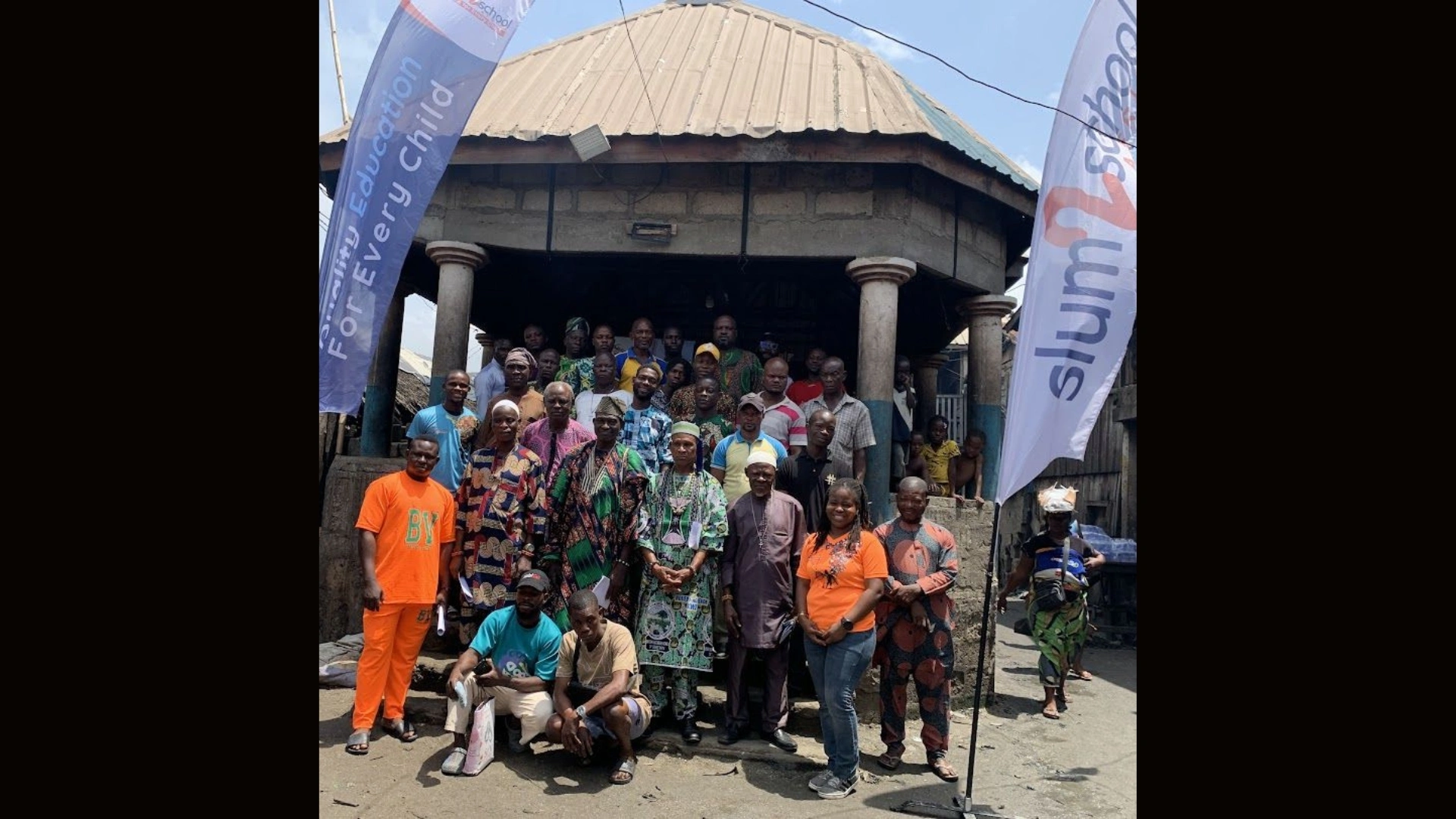 Slum2School Africa Program Manager Patience Osinaike and a group of community leaders, religious leaders, and household heads at a sensitization session in Mainland LGA.