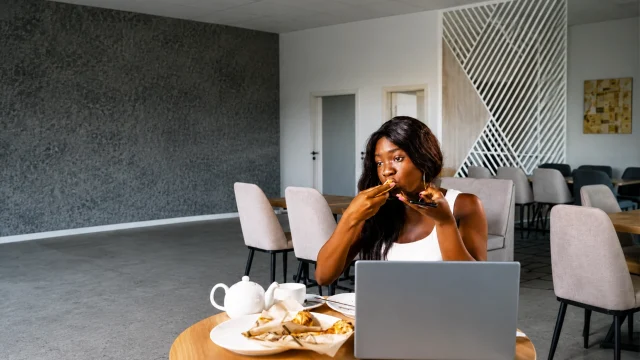 Woman eating at the cafeteria