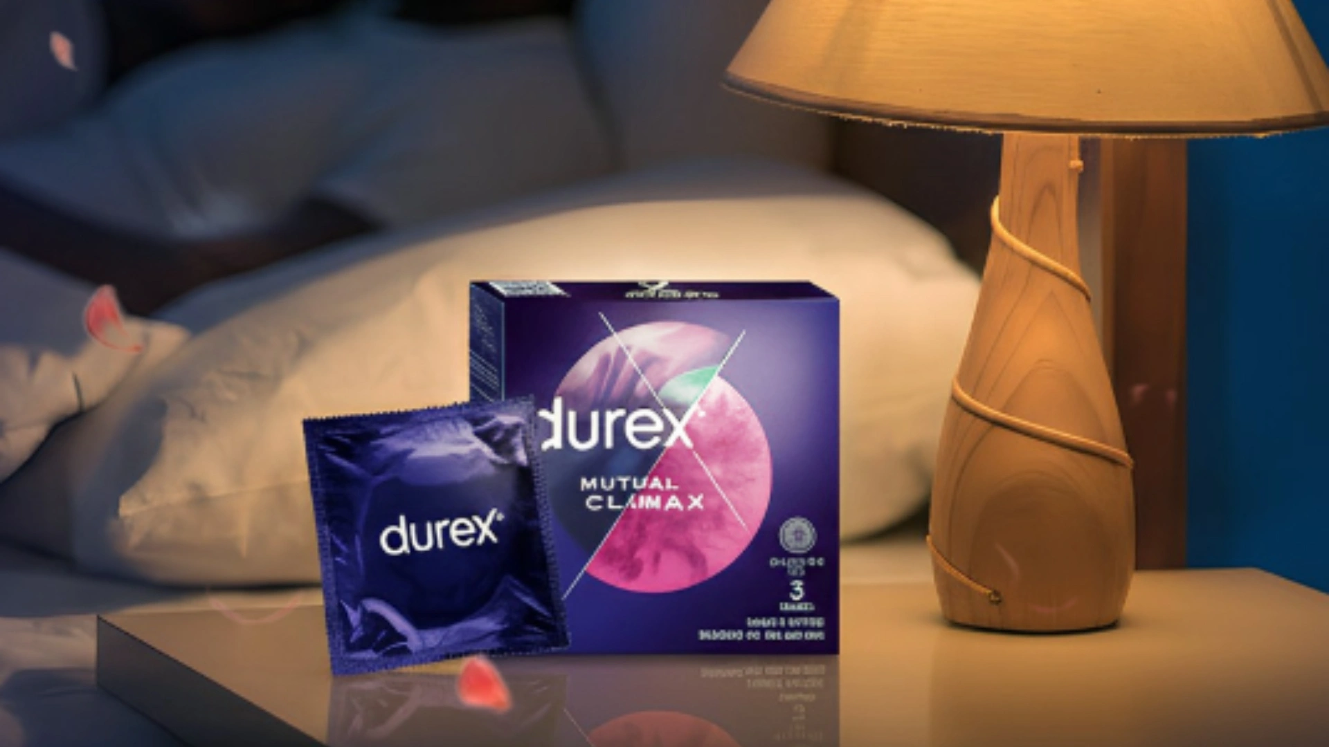 A pack of Durex condoms by a bedside lamp