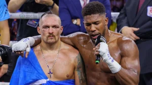 Anthony Joshua (R) of Great Britain congrats the winner Oleksandr Usyk (L) of Ukraine after boxing rematch under the name of “Rage in the Red Sea” as he retains world title at King Abdullah Sports Complex in Jeddah