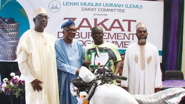 Chairman, Zakat Committee, Lekki Muslim Ummah (LEMU), Alhaji Yunus Saliu (left); President LEMU, Dr AbdulGaniy Labinjo; a beneficiary of the motorcycle, Sulaiman Alabi Ashiru, and Chief Imam, Lekki Central Mosque. Dr Ridwan Jamiu, during the 2026 Lekki Muslim Ummah Zakat Disbursement programme held in Lekki, Lagos.