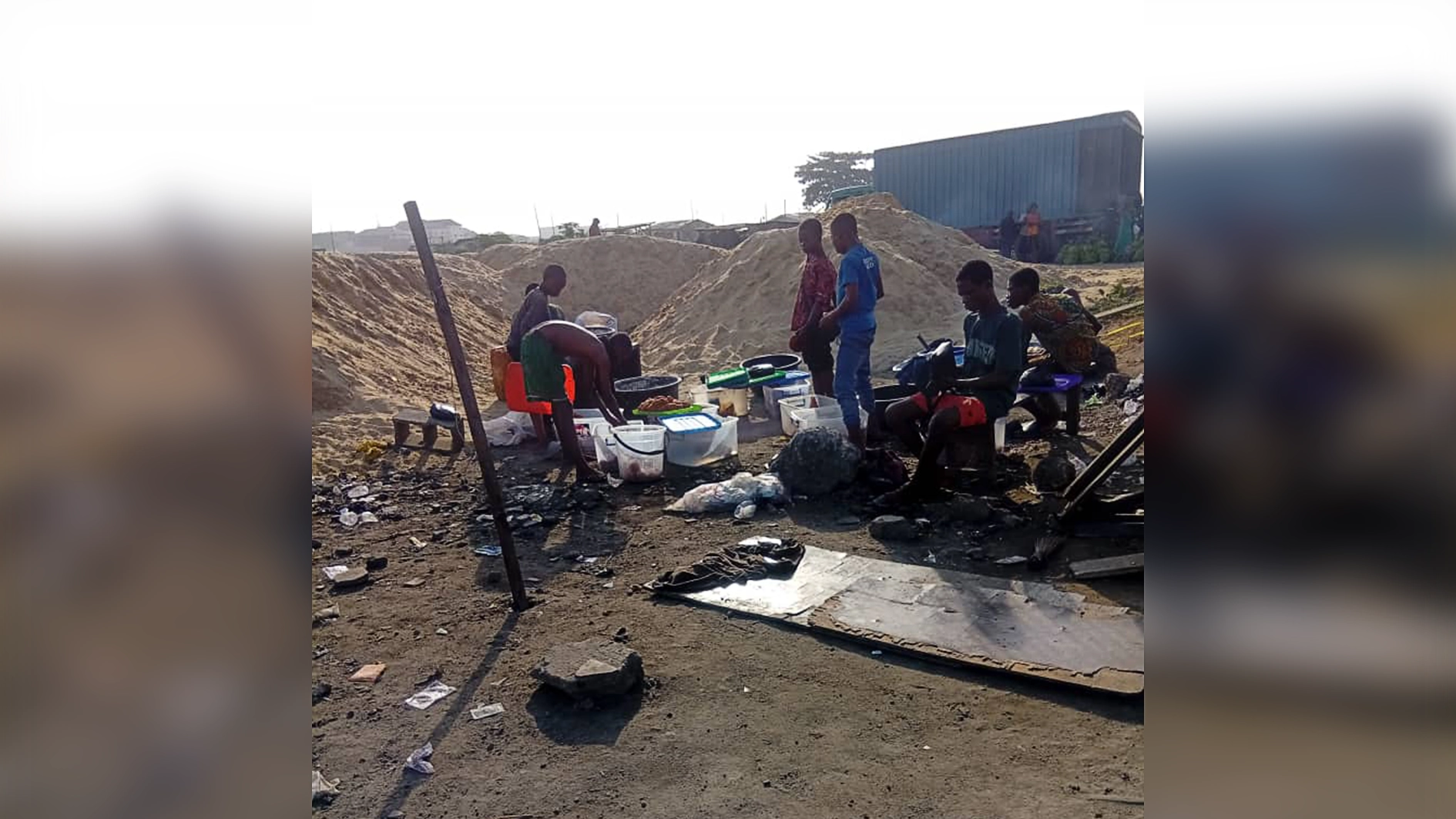 Underage boys preparing to hawk puff puff after abandoning schools due to the demolition of their homes