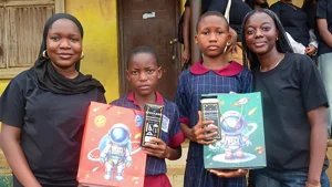 Fareedah (left) and Ifeoluwa (right) with two students who benefitted from the outreach