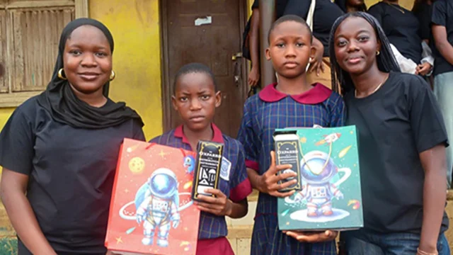 Fareedah (left) and Ifeoluwa (right) with two students who benefitted from the outreach