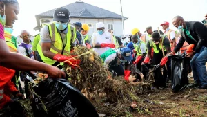 Tokunbo Wahab (left) and state official during the Monthly Environmental Sanitation exercise at Alimosho Local Council…on Saturday.