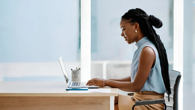 A young Nigerian woman working on laptop 2