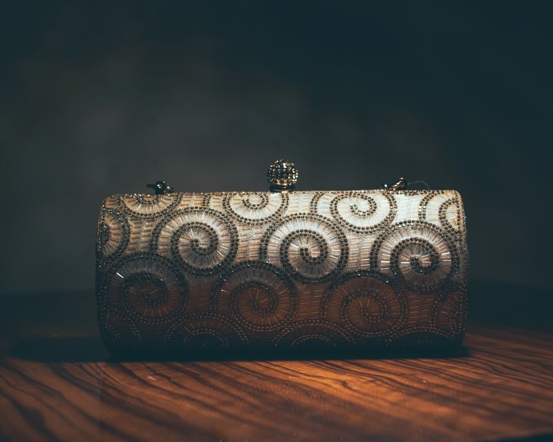 Stylish clutch bag with a textured pattern and elegant design, suitable for both casual and formal wear.