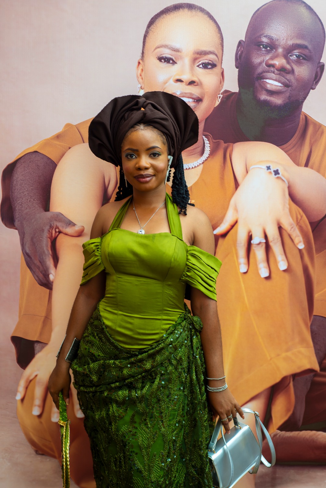 A stylish young woman showcasing the elegance and cultural richness of Aso Ebi fashion.