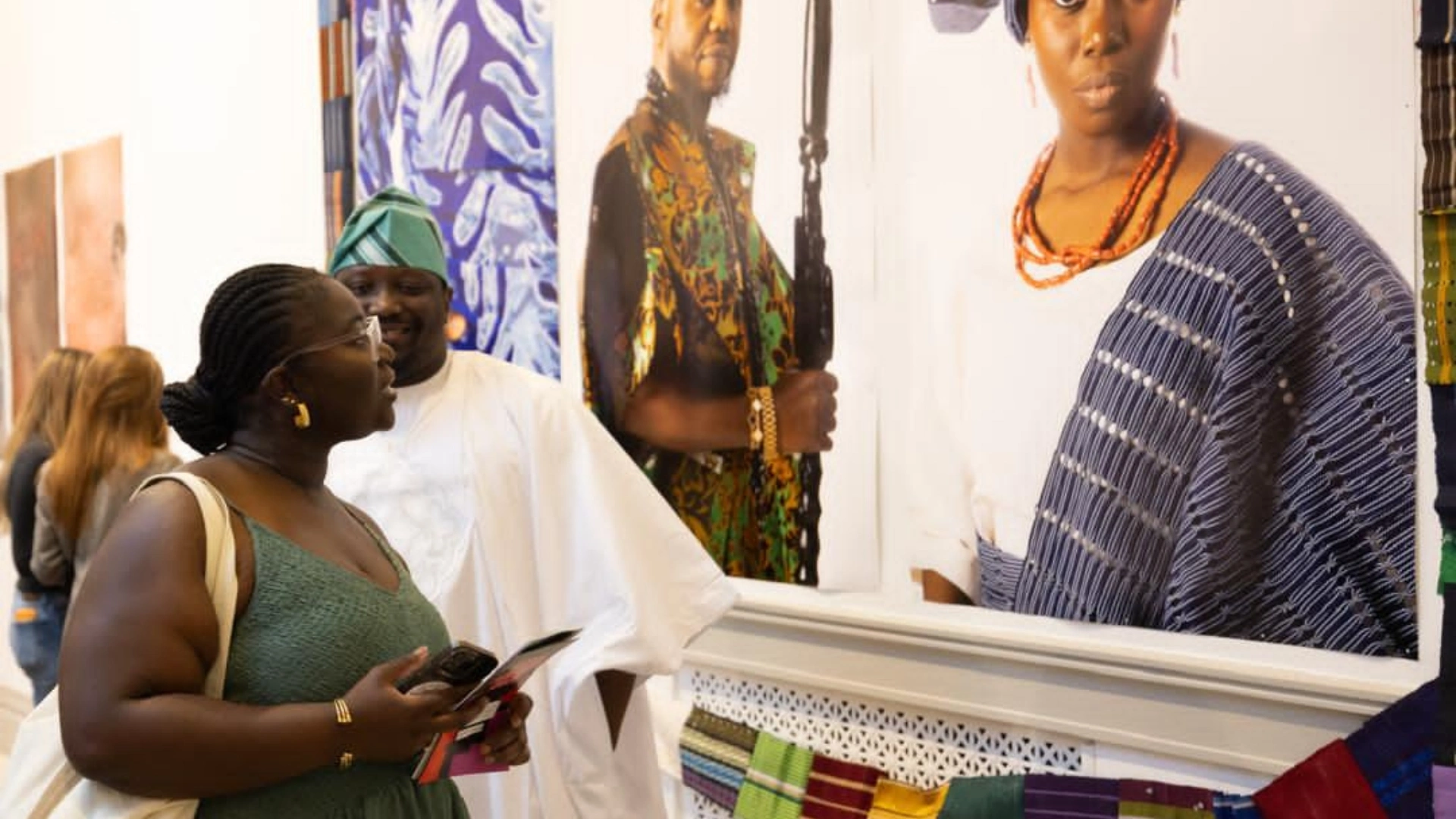 Oluwafemi Oluwatobi Olajide explains one of his works to a guest at the 2026 Next Festival hosted by The George Washington University's Corcoran School of the Arts and Design in Washington, D.C