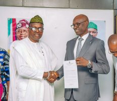 Dr. Donald Ibe Ofili receiving his letter from Minister of State for Health and Social Welfare, Dr Iziaq Adekunle Salako