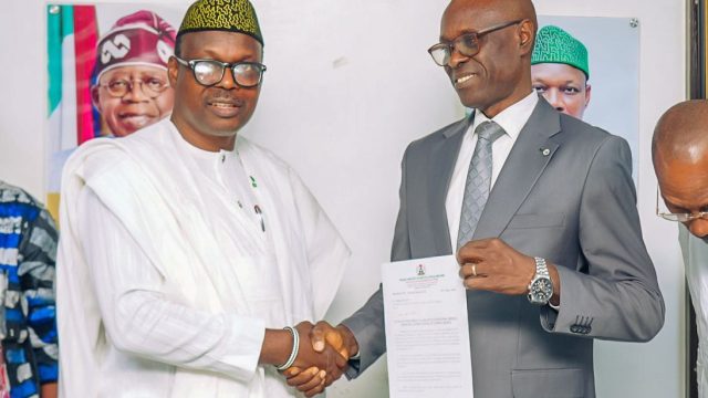 Dr. Donald Ibe Ofili receiving his letter from Minister of State for Health and Social Welfare, Dr Iziaq Adekunle Salako