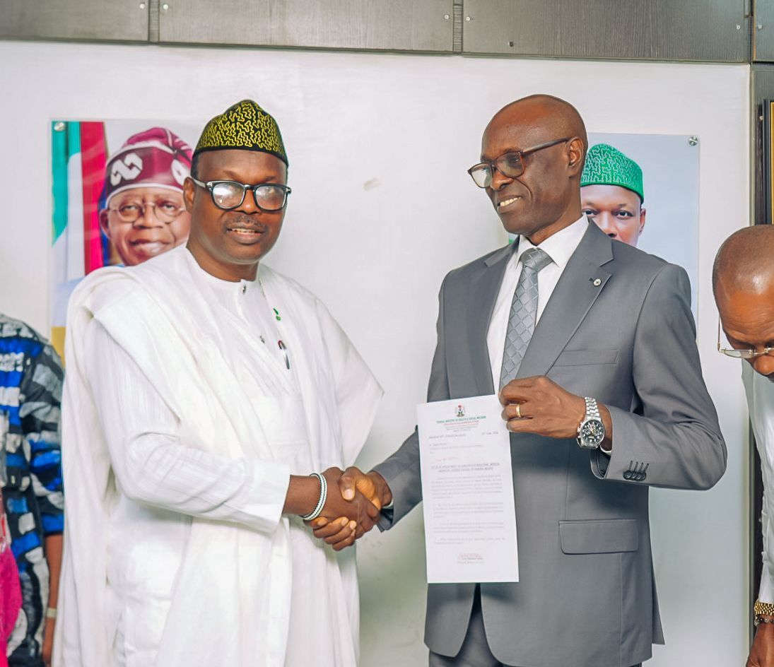 Dr. Donald Ibe Ofili receiving his letter from Minister of State for Health and Social Welfare, Dr Iziaq Adekunle Salako