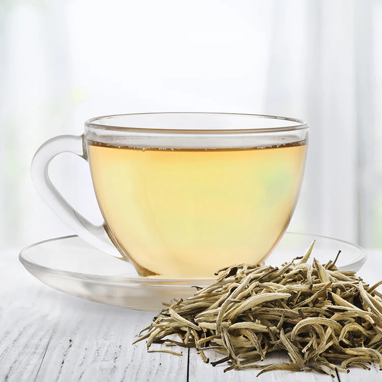 A warm cup of White Tea served in a ceramic mug, known for its calming properties, soothing aroma, and potential wellness benefits.