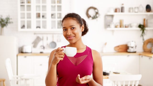 Indoor shot of self confident beautiful joyful young black dark