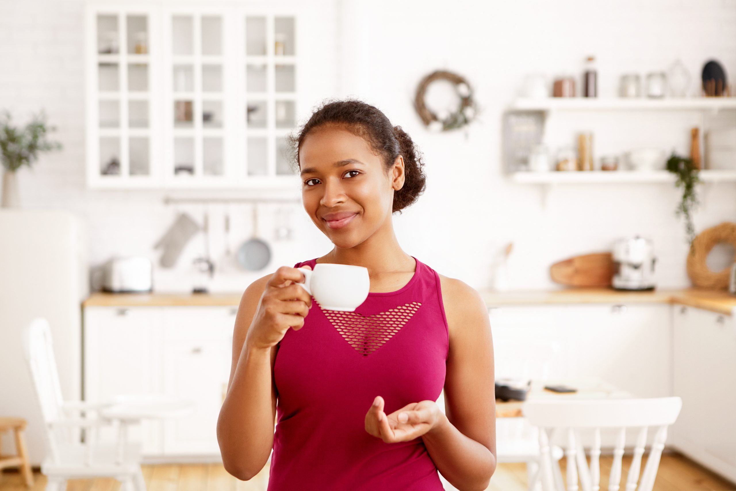 Indoor shot of self confident beautiful joyful young black dark