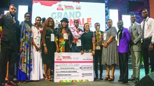 Winner, Crunchies Spelling Bee Competition (TCSBC), Grace Ihunanyachi Ogechukwu (middle); Managing Director, Crunchies Fried Chicken, Muka Ohaeji; with executives, judges, and school representatives at the Spelling Bee Competition in Aba, recently.