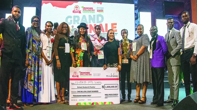 Winner, Crunchies Spelling Bee Competition (TCSBC), Grace Ihunanyachi Ogechukwu (middle); Managing Director, Crunchies Fried Chicken, Muka Ohaeji; with executives, judges, and school representatives at the Spelling Bee Competition in Aba, recently.