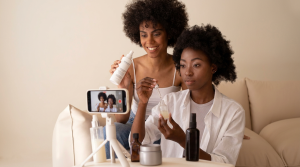 Women with afros sitting with beauty products