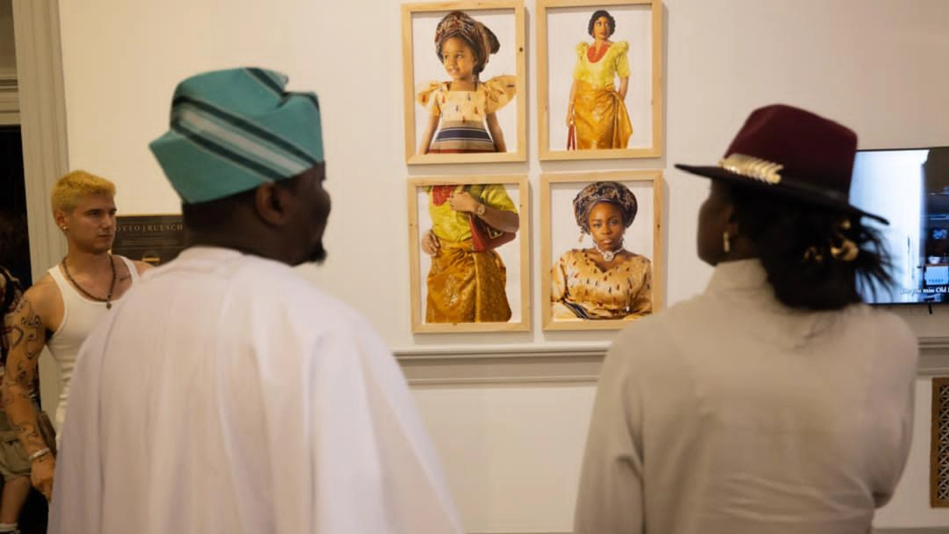 Oluwafemi Oluwatobi Olajide explains another of his works to a guest at the 2026 Next Festival hosted by The George Washington University's Corcoran School of the Arts and Design in Washington, D.C