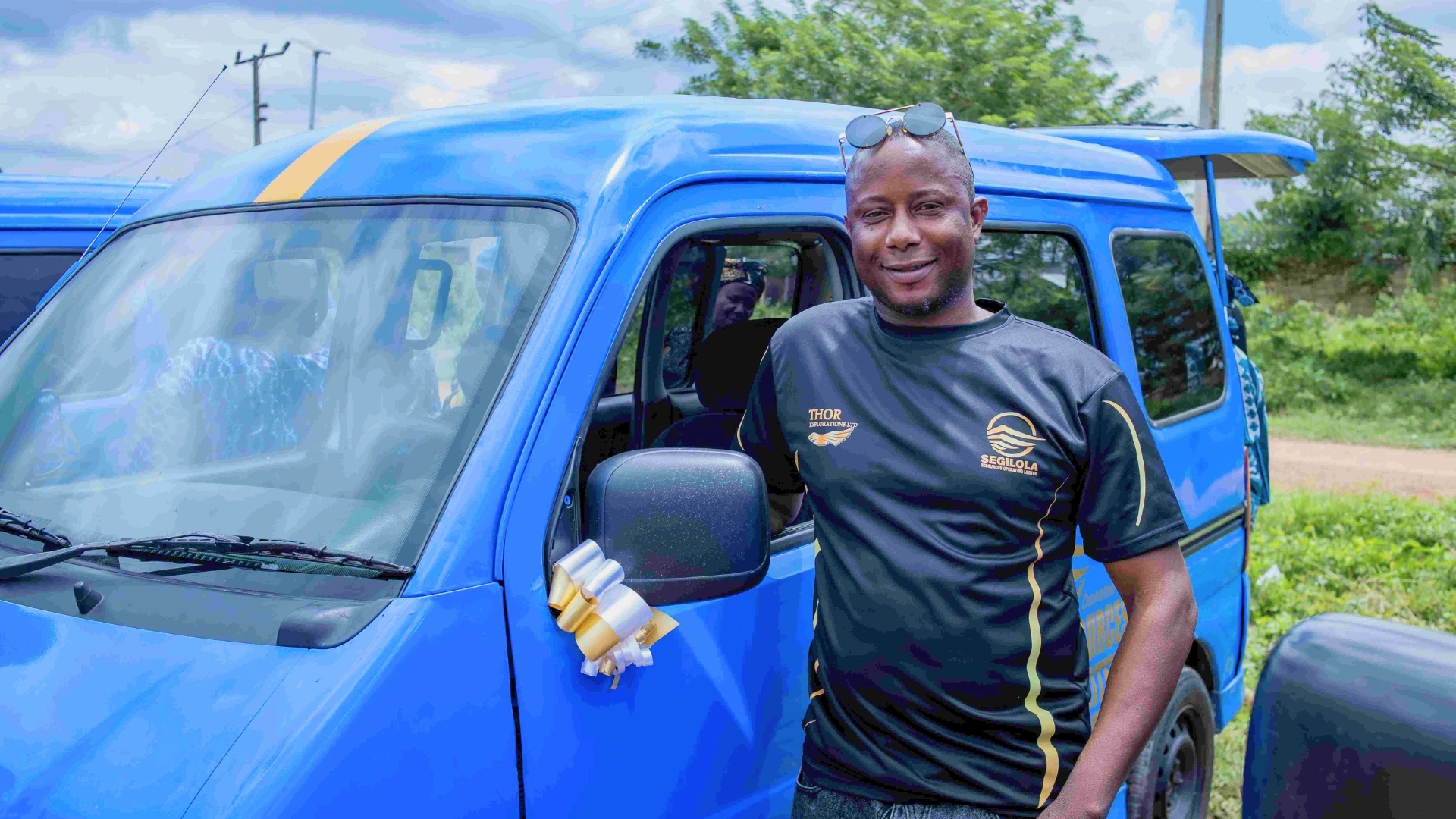 A man standing beside a minibus