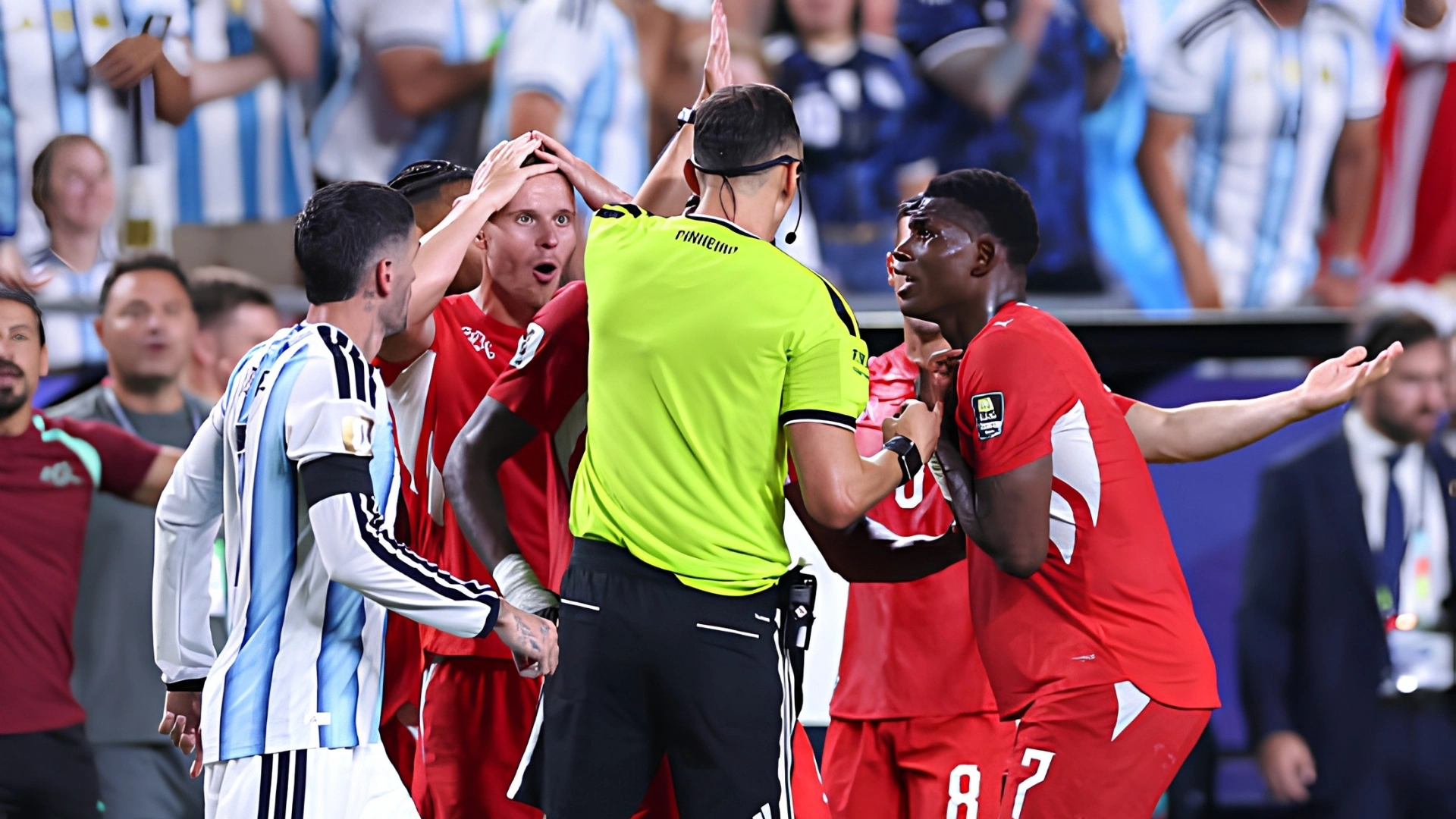 Players appeal to the referee after a controversial World Cup decision.