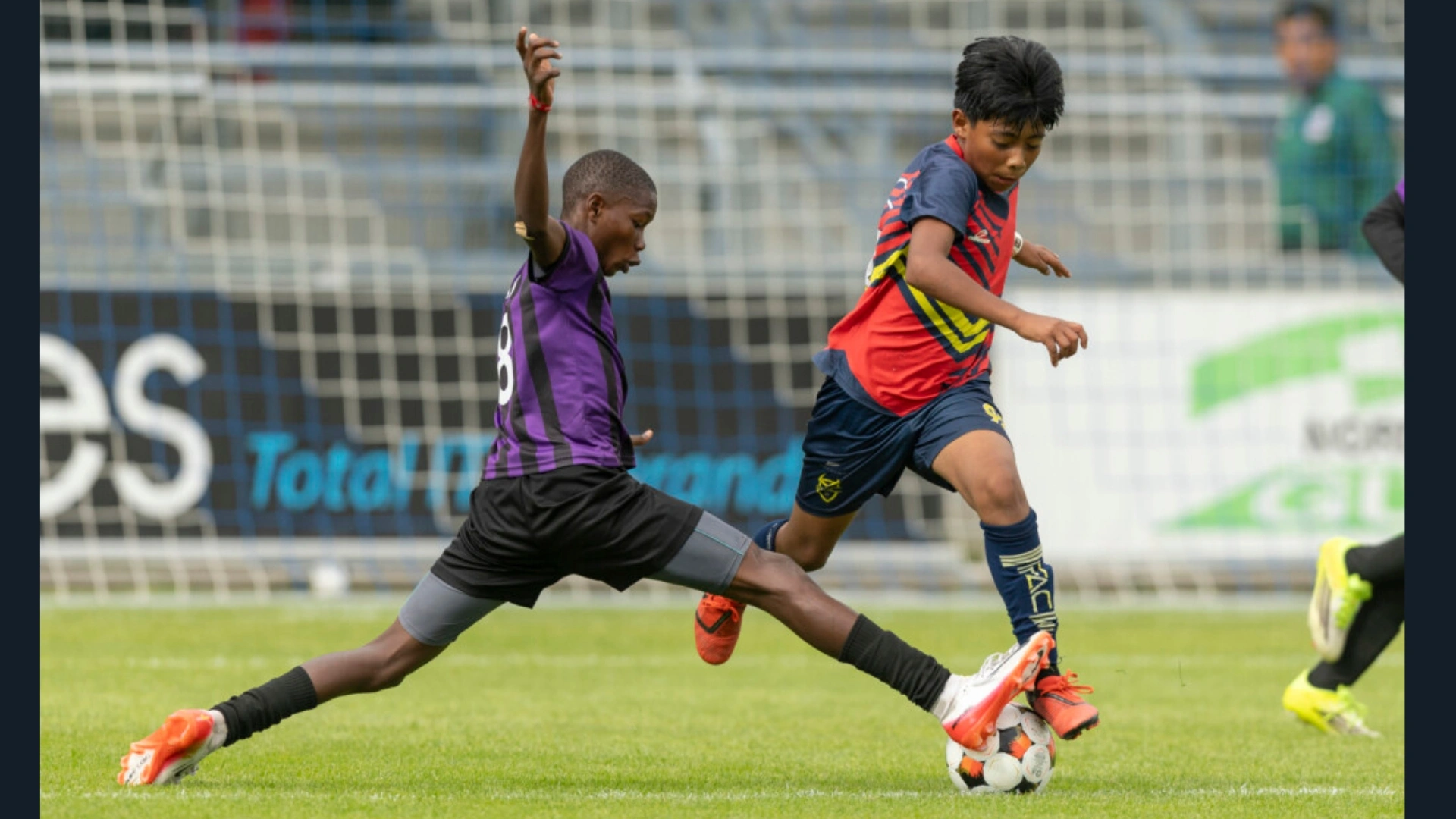 A Dazzle FC' U12 player tackles an opponent during the final match against Mexico's IFAC at the Dana Cup in Denmark.