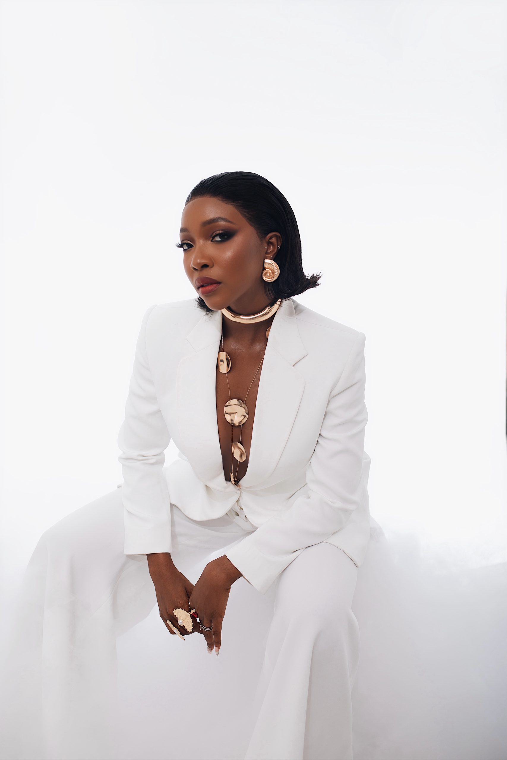 Nigerian actress Ini Dima-Okojie wearing a chic, elegant outfit while posing confidently for a fashion portrait.