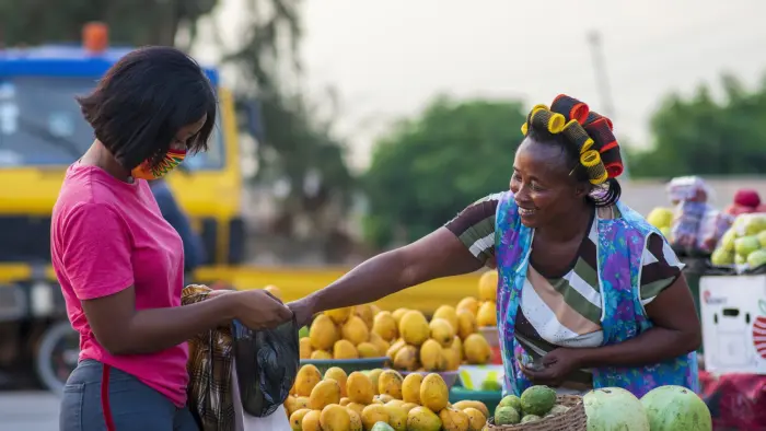 Woman buying fresh fruits at a local market