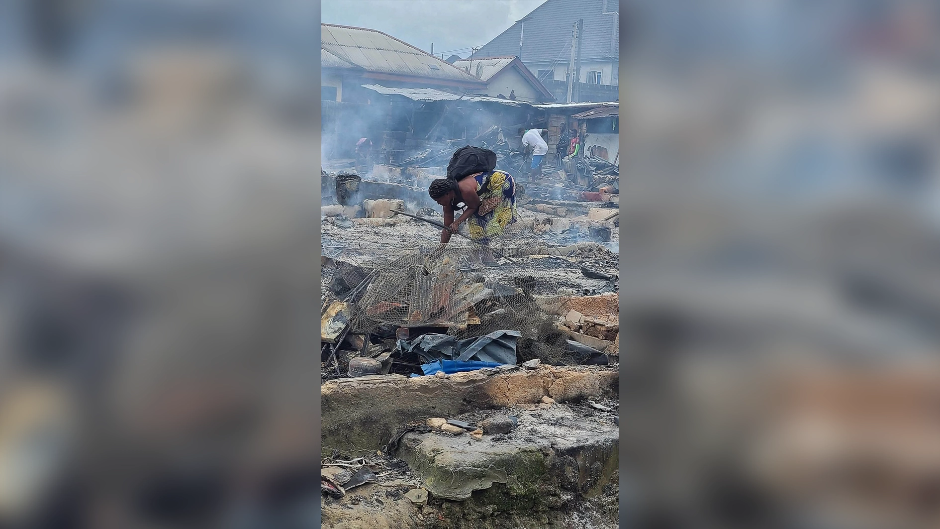 Affected residents rummage  charred remains of property.