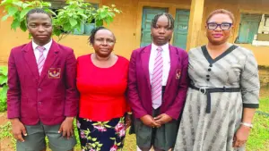 One of the beneficiaries of the scholarship initiative, Qureeb Adekunle (left);  Headmistress, Olowora Public Nursery and Primary School, Mrs Temitope Olasode, second beneficiary, Bilikisu Abdulraheem, and Assistant Headmistress, Mrs Dairo Josephine at the event in Lagos.