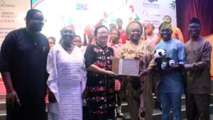 Chairman, Parent Teachers Association, Grace Children School, Mr Omoruyi Edoigiawerie; Head of School, Grace Children School, Dr Nike Akindayo; Consul General, Chinese Embassy, Lagos, Ms Yan Yuqinq; CEO, Grace Schools, Mrs Olatokunbo Edun; Head of Chinese Unit, Dept of Lingustics, African and Asian Studies, University of Lagos, Dr Adetoro Banjo and Deputy Head of School, Grace Children School,Mr Paul Ibe with Grace Schools students during the visit of the Consul General to the school in Gbagada, Lagos.