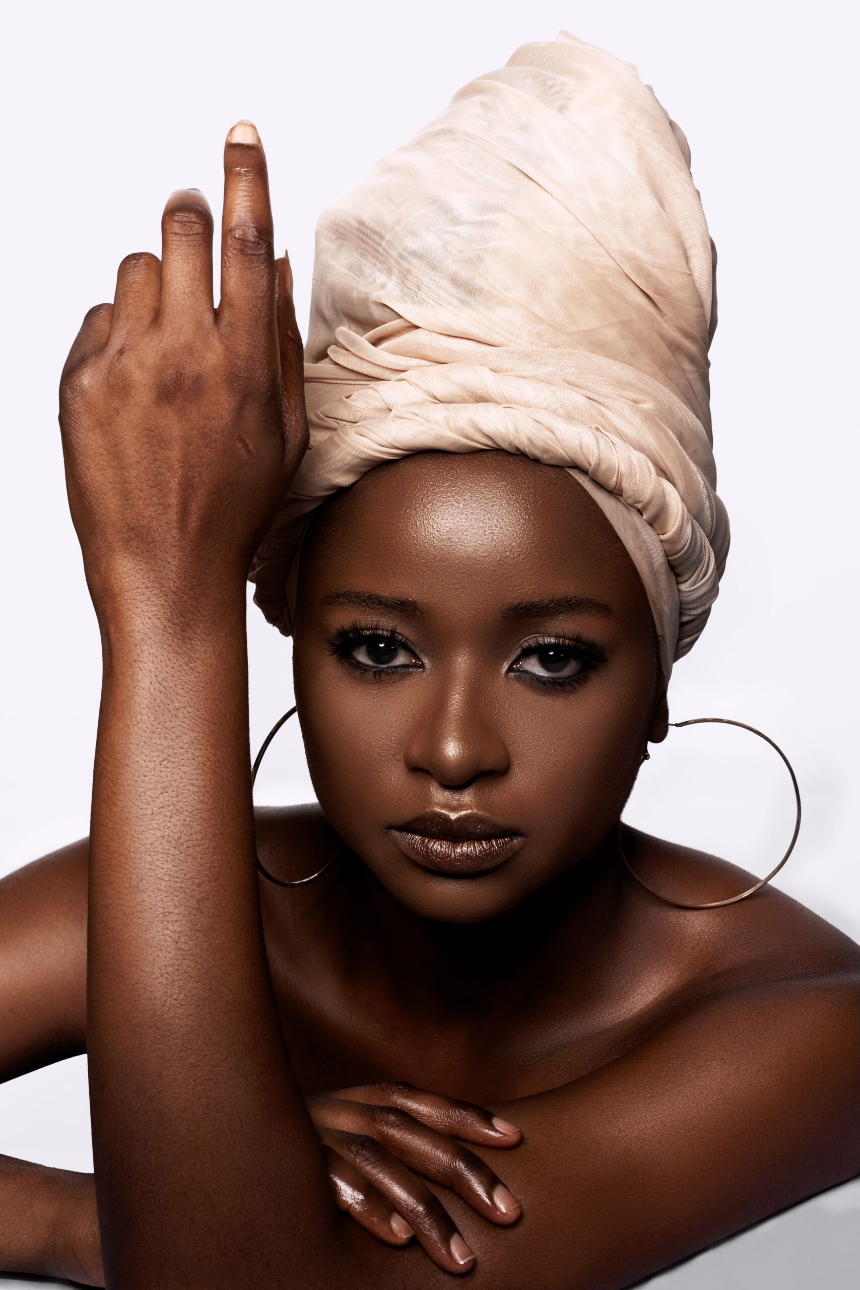 A beautifully crafted twisted crown head wrap featuring sculpted twists that create a regal, crown-like silhouette. Perfect for weddings, cultural celebrations, formal events, and contemporary African fashion.