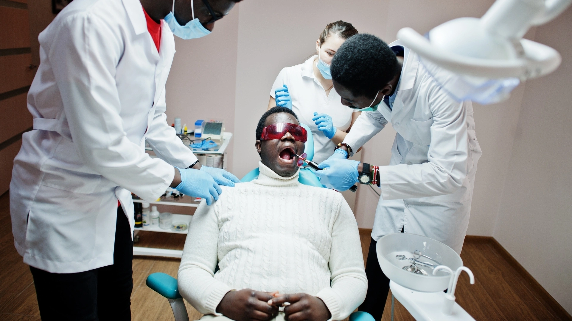 A dental team conducting a routine oral health examination on a patient