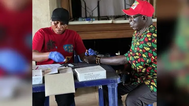 A community leader being screened at Anaocha community by ANSACA health officials
