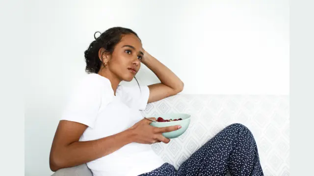 Young woman eating comfort food