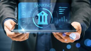 online-banking-concept-with-digital-classic-bank-building-symbol-laptop-monitor-businessman-hands-min-scaled-1
