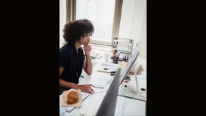 woman-working-in-front-of-a-desktop-computer