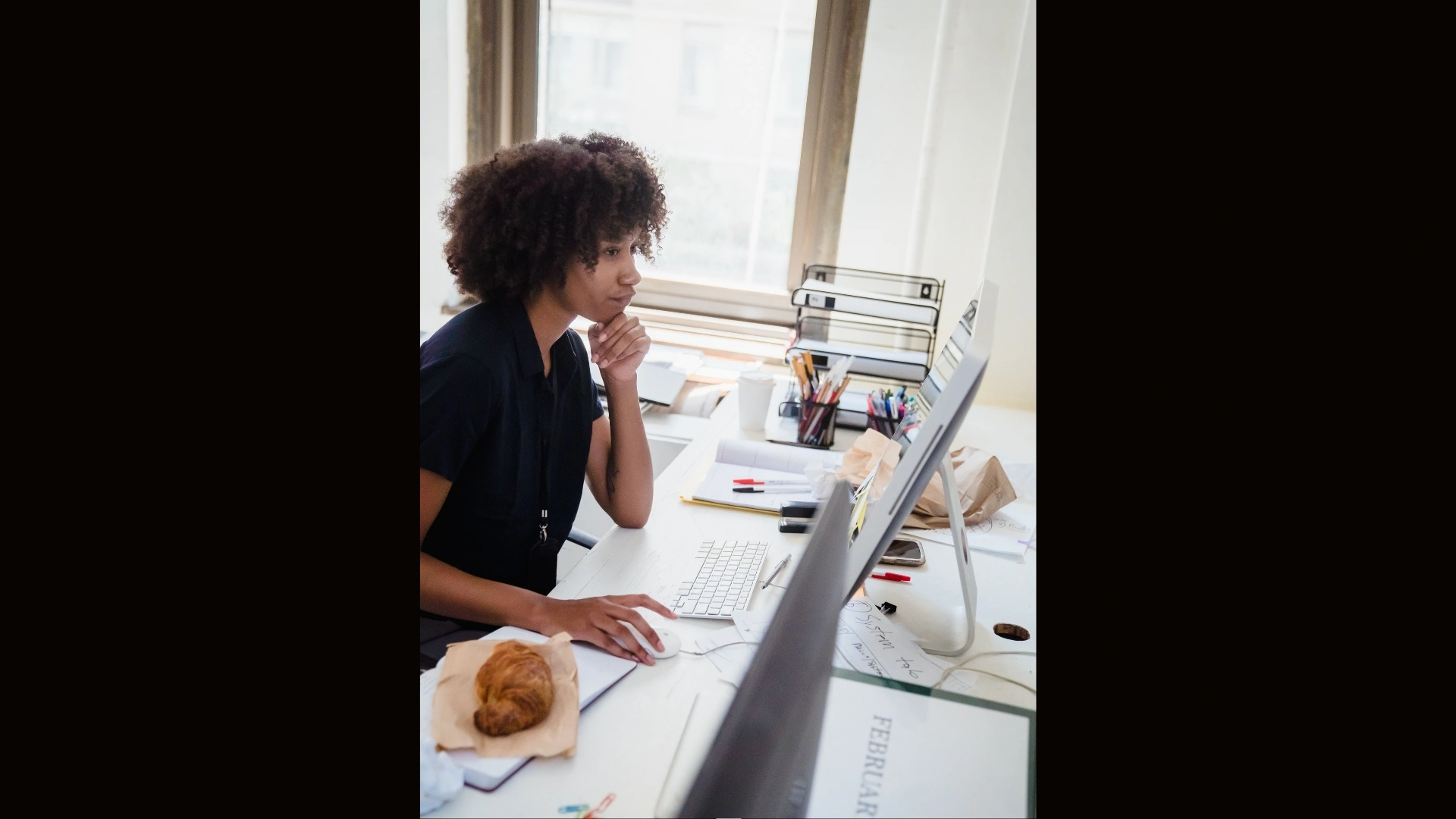 woman-working-in-front-of-a-desktop-computer