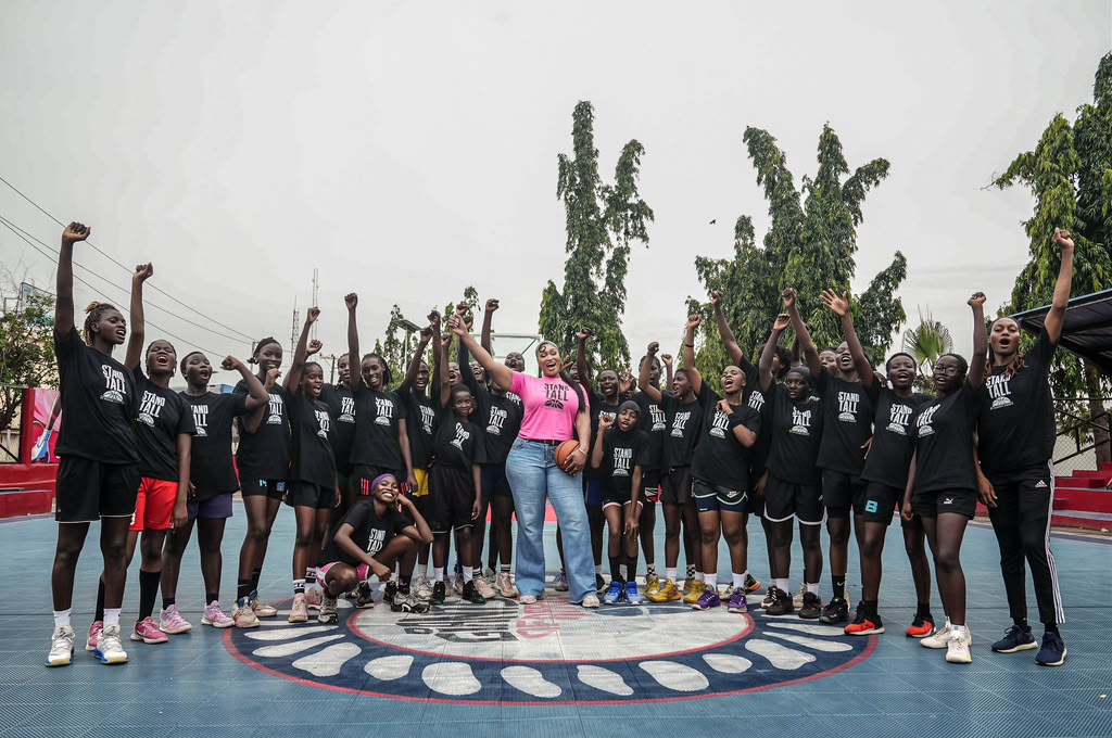 Chinyere Ibekwe (centre) with young players at an I Stand Tall basketball clinic