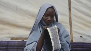Fatimah Ali stitching a fabric.