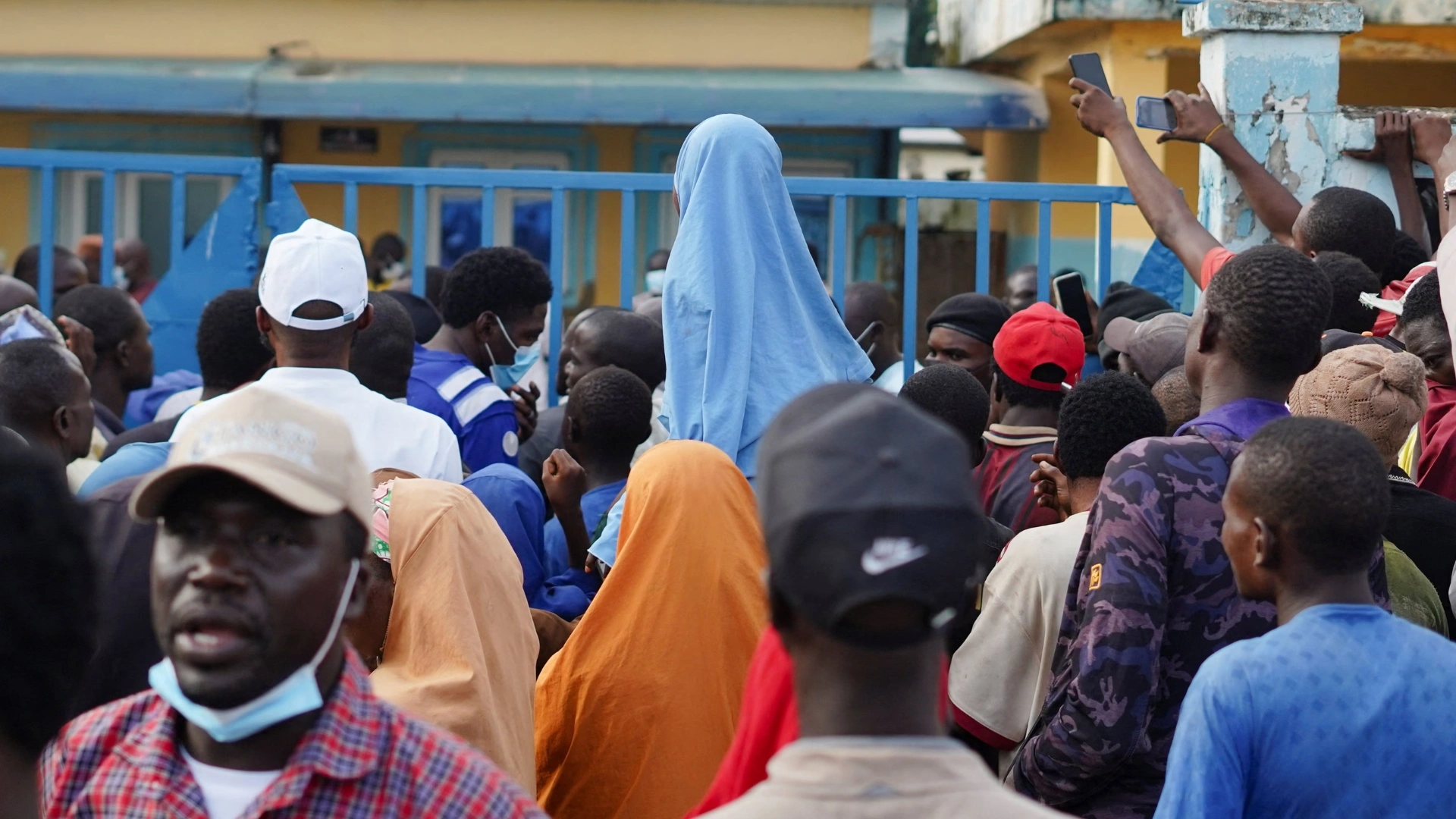 Family members of those who died gather outside Minna general hospital in Niger state.