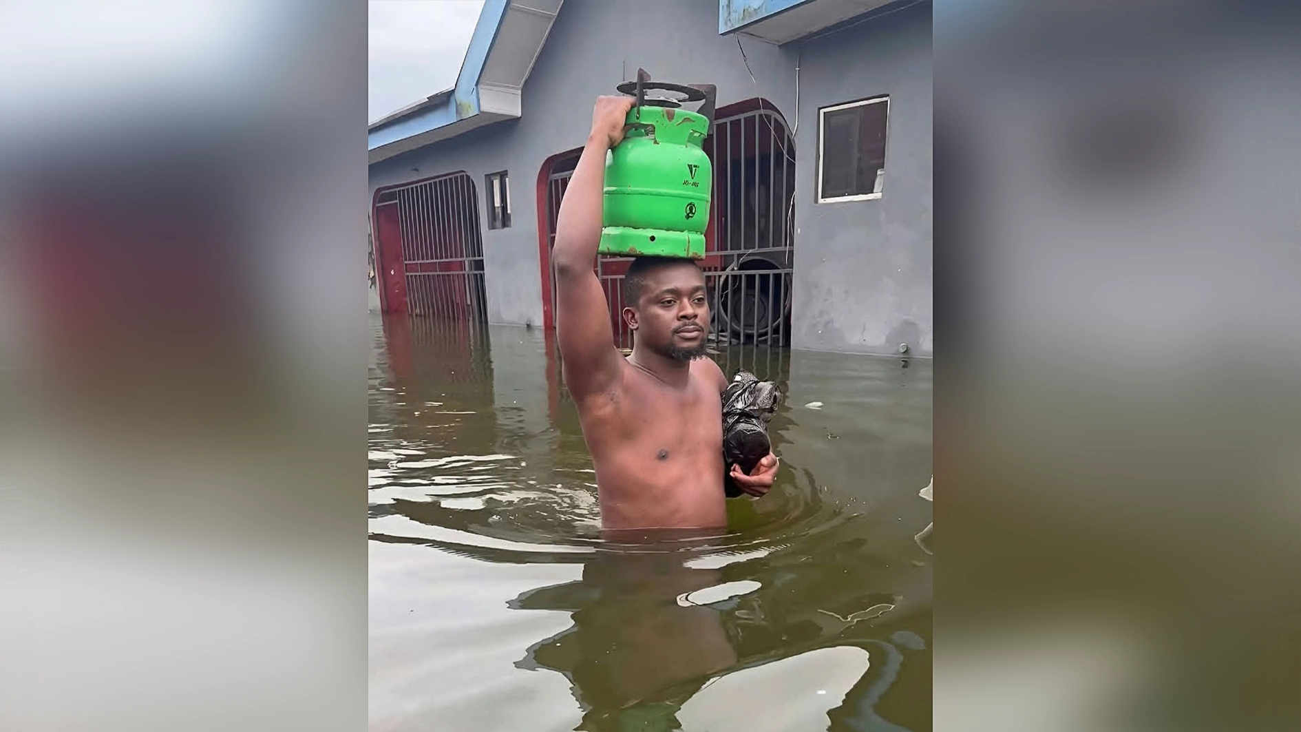 Port Harcourt residents wading through water,  yesterday