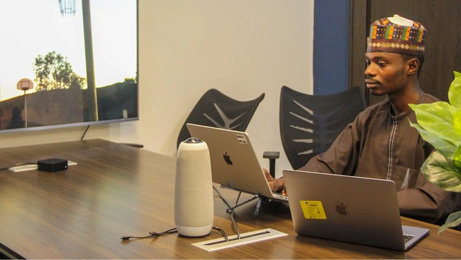 A member of Distinction AI team coding at FlexiSaf’s office in Garki, Abuja, Nigeria.